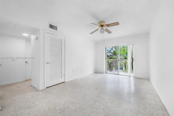 an empty room with windows and closet