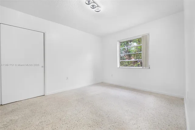 a view of kitchen with white cabinets