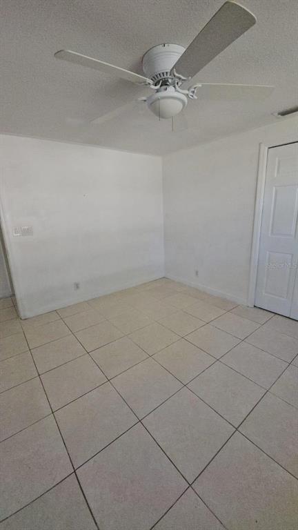 4208 8th St Court East Bradenton, FL 34208 - Photo 22 of 33 a view of a room with an empty space and a ceiling fan