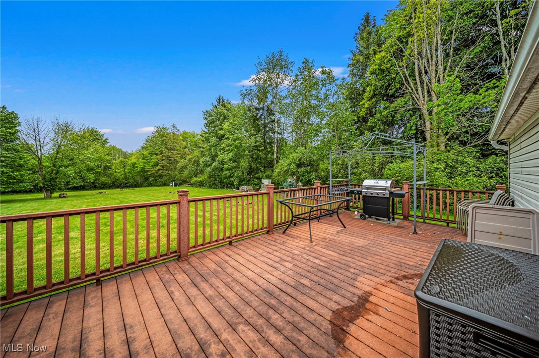 6835 Sidley Road Thompson, OH 44086 - Photo 9 of 39 Deck featuring a grill and a yard