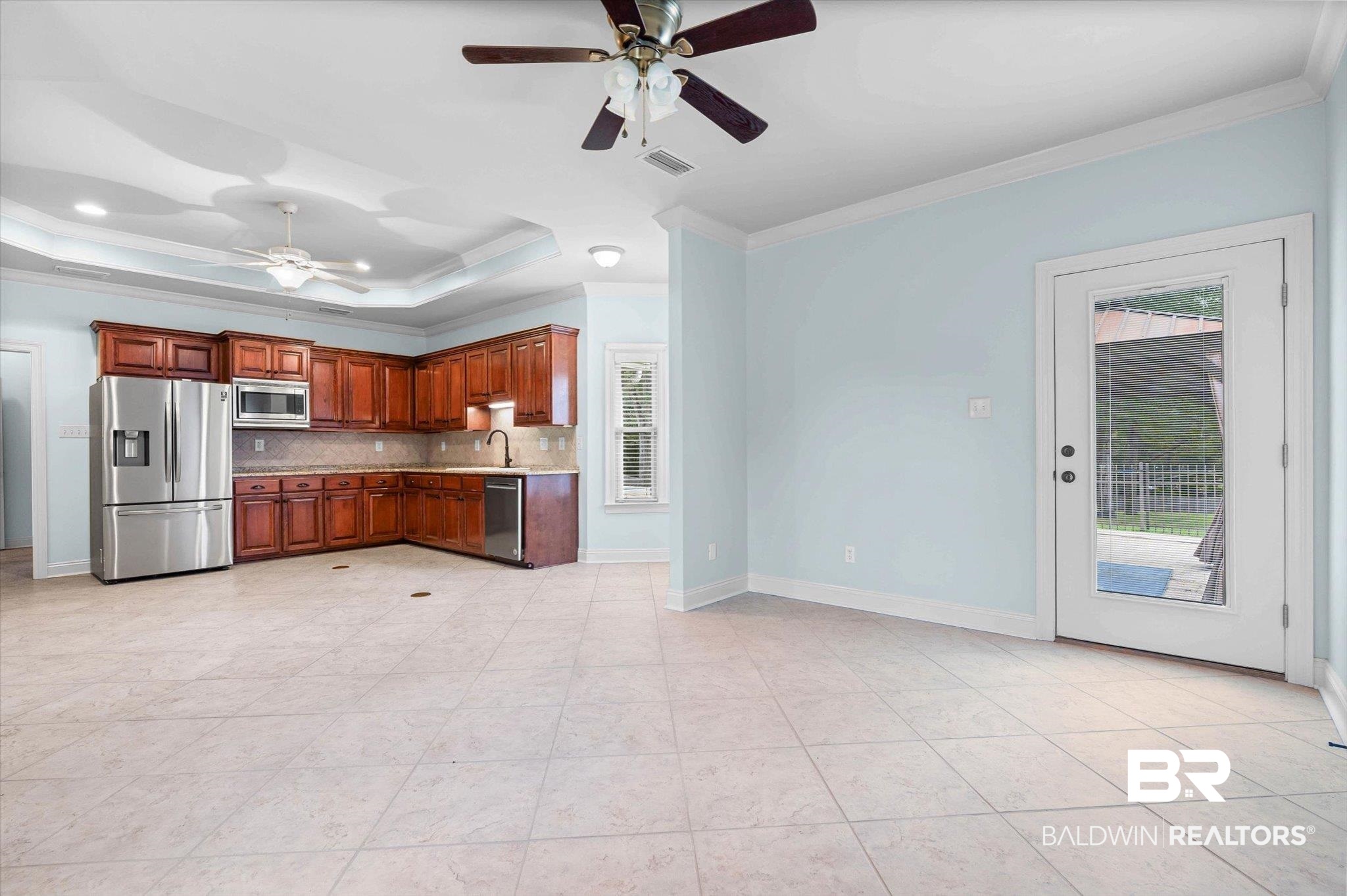 5270 Rodgers Road Eight Mile, AL 36613 - Photo 21 of 38 Kitchen featuring ornamental molding, ceiling fan, stainless steel appliances, a tray ceiling, and decorative backsplash