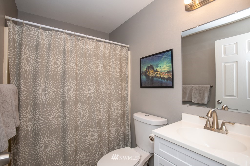 1119 Merea Lane Sultan, WA 98294 - Photo 14 of 20 a bathroom with a toilet a sink and a shower curtain
