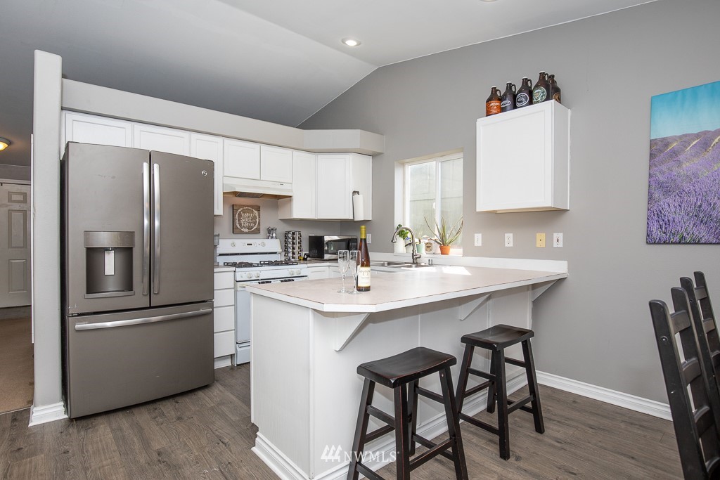 1119 Merea Lane Sultan, WA 98294 - Photo 7 of 20 a kitchen with stainless steel appliances a refrigerator a sink a stove a table and chairs