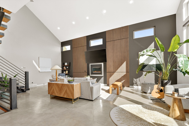 14902 Saddle Leaf Court Draper, UT 84020 - Photo 11 of 52 Living area with a glass covered fireplace, recessed lighting, concrete floors, healthy amount of natural light, and vaulted ceiling