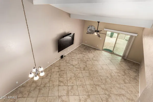 a view of a livingroom with furniture and chandelier fan