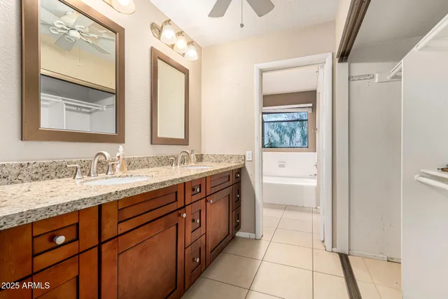 a spacious bathroom with a granite countertop sink mirror and a