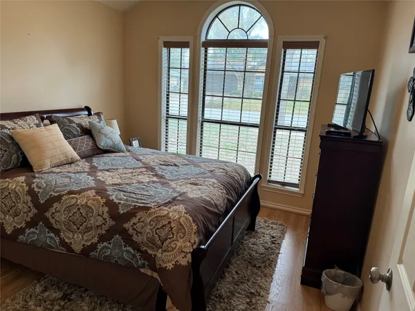 a bedroom with a large bed and a window