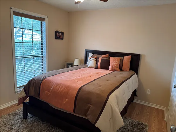 a large bed sitting in a bedroom next to a window