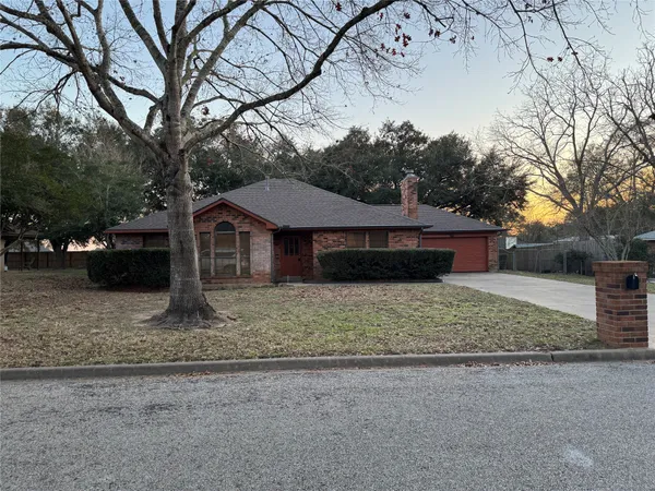 a house that has a tree in front of it