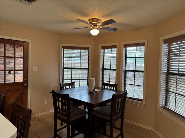 a view of a dining room with a table and chairs