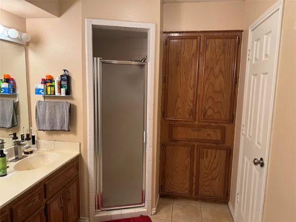 a bathroom with a sink a mirror and a shower