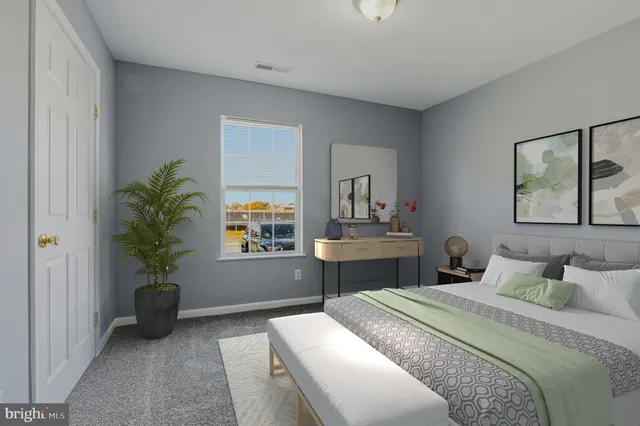 a bedroom with a bed table flowerpot and window