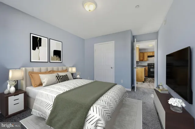 a bedroom with a bed and a flat screen tv