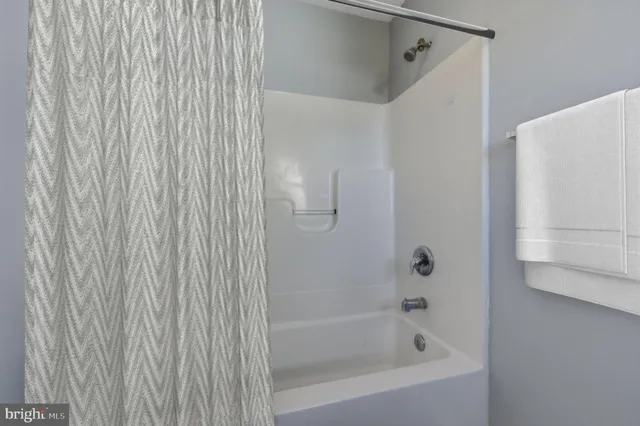 a close up of a bathtub curtain
