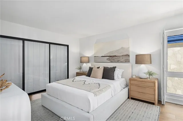 a bedroom with a bed and a night stand