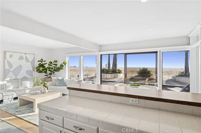 a living room with furniture and a floor to ceiling window