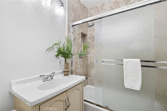 a bathroom with a sink a mirror and a bathtub