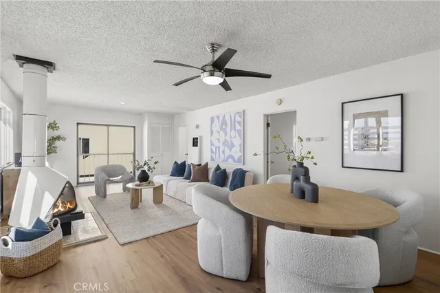 a living room with dining table and wooden floor