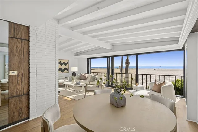 a dining room with furniture and a large window