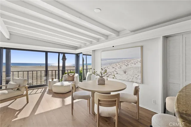 a dining room with furniture and a floor to ceiling window