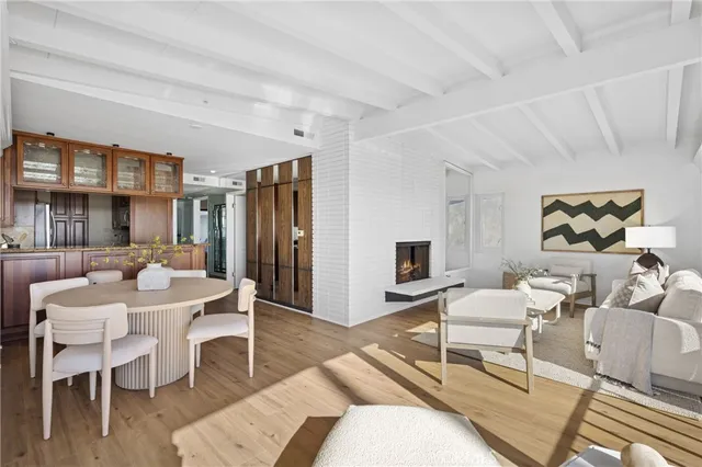 a living room with furniture a wooden floor and next to a window