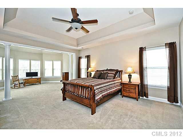 265 Lorraine Road, Unit 15 Fort Mill, SC 29708 - Photo 6 of 16 a spacious bedroom with a bed a chandelier and a large window