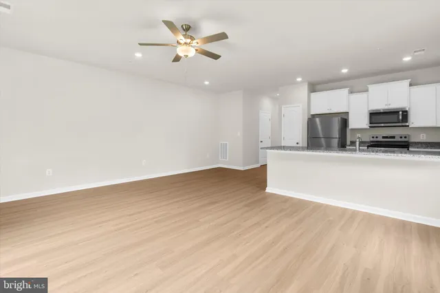 a kitchen with granite countertop a sink and a stove