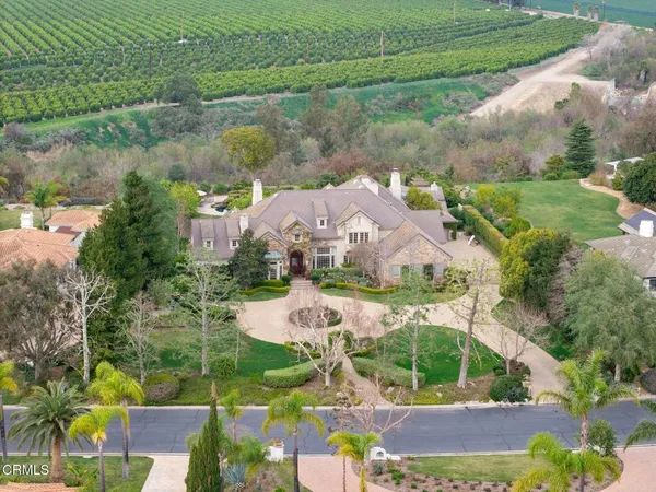 an aerial view of residential houses with outdoor space and street view