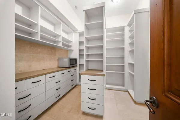 a view of walk in closet with empty racks