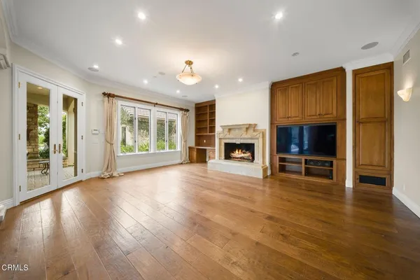a view of an empty room with a window and fire place
