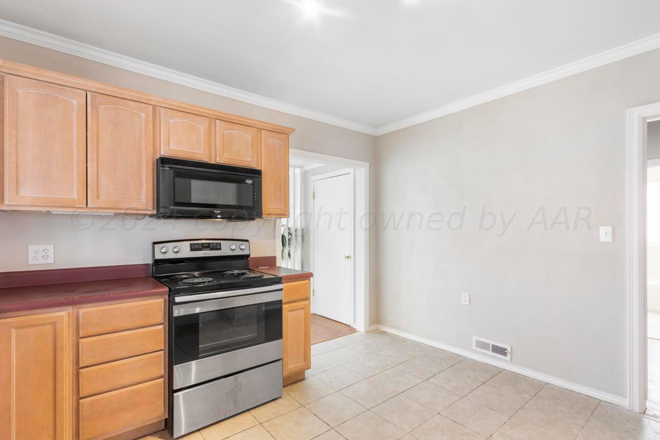 1026 Sunset Terrace Amarillo, TX 79106 - Photo 16 of 44 a kitchen with granite countertop white cabinets stainless steel appliances and a sink