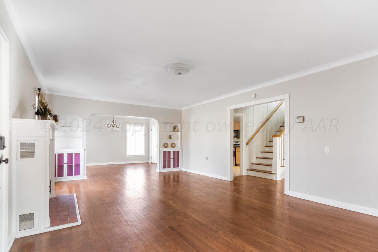 1026 Sunset Terrace Amarillo, TX 79106 - Photo 4 of 44 an empty room with wooden floor and windows