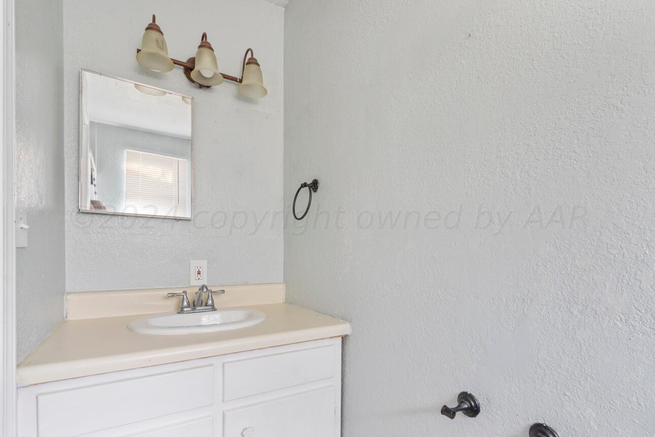 1026 Sunset Terrace Amarillo, TX 79106 - Photo 42 of 44 a bathroom with a sink and a mirror