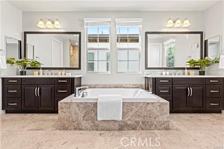 51 Dunmore Irvine, CA 92620 - Photo 17 of 23 a spacious bathroom with a tub sink and mirror
