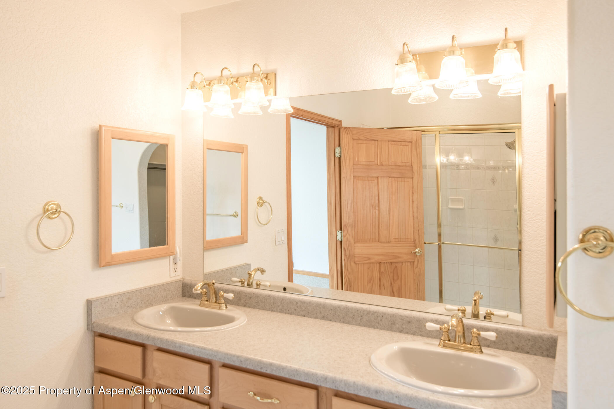 1230 Fir Avenue Rifle, CO 81650 - Photo 16 of 34 a bathroom with a granite countertop sink and a mirror