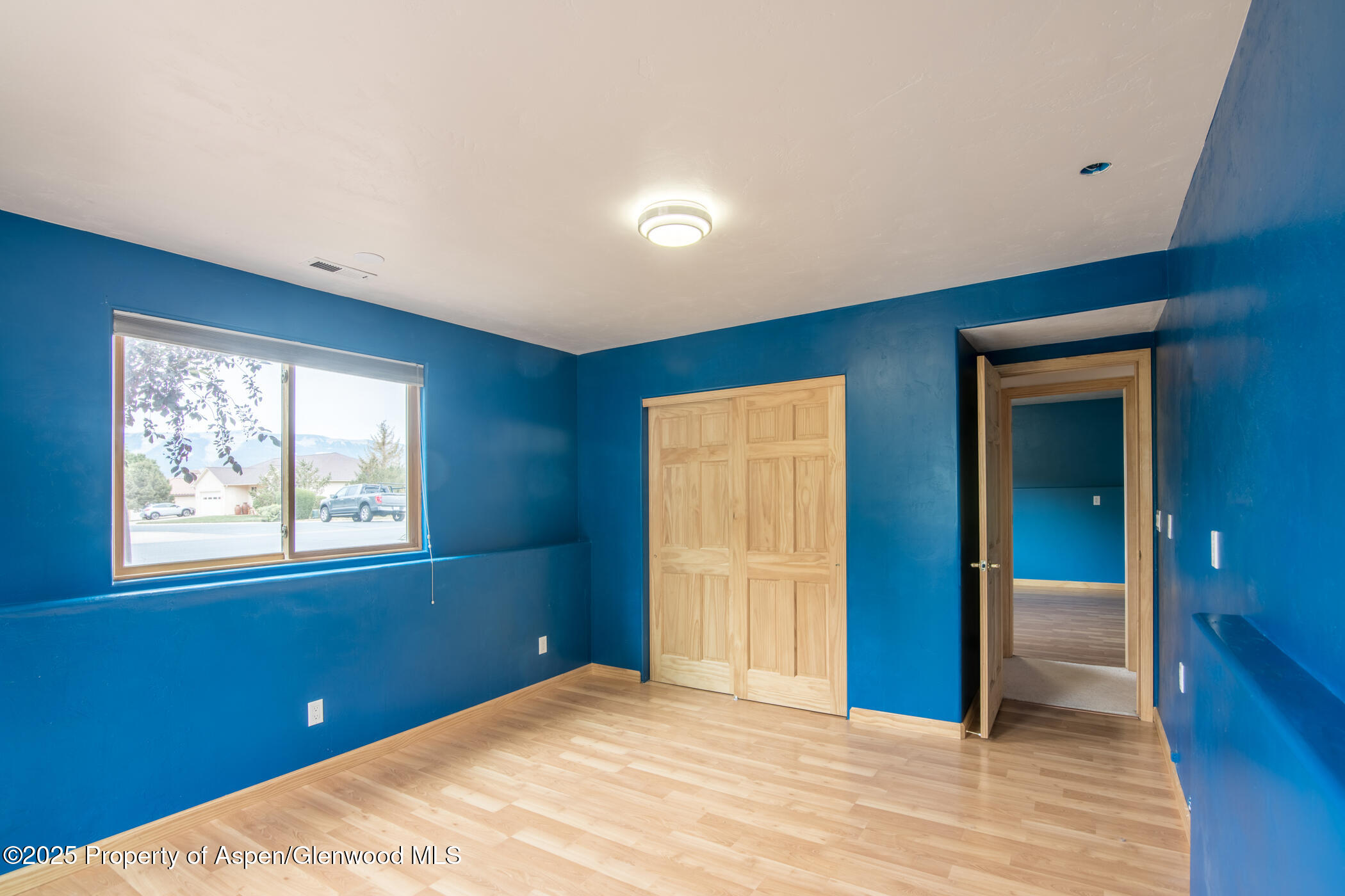1230 Fir Avenue Rifle, CO 81650 - Photo 26 of 34 a view of an empty room with wooden floor and a window