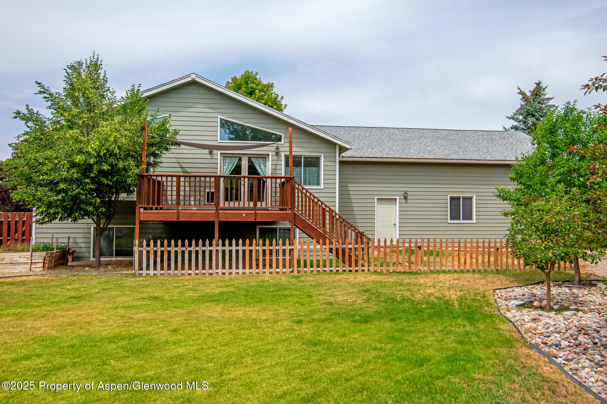 1230 Fir Avenue Rifle, CO 81650 - Photo 3 of 34 a front view of a house with a garden