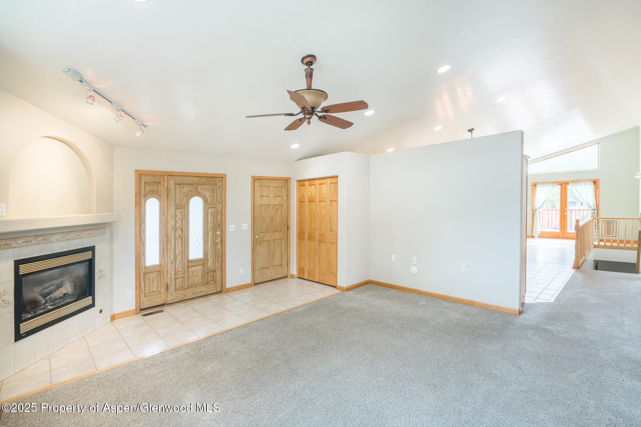 1230 Fir Avenue Rifle, CO 81650 - Photo 6 of 34 a view of a livingroom with a fireplace and a chandelier fan
