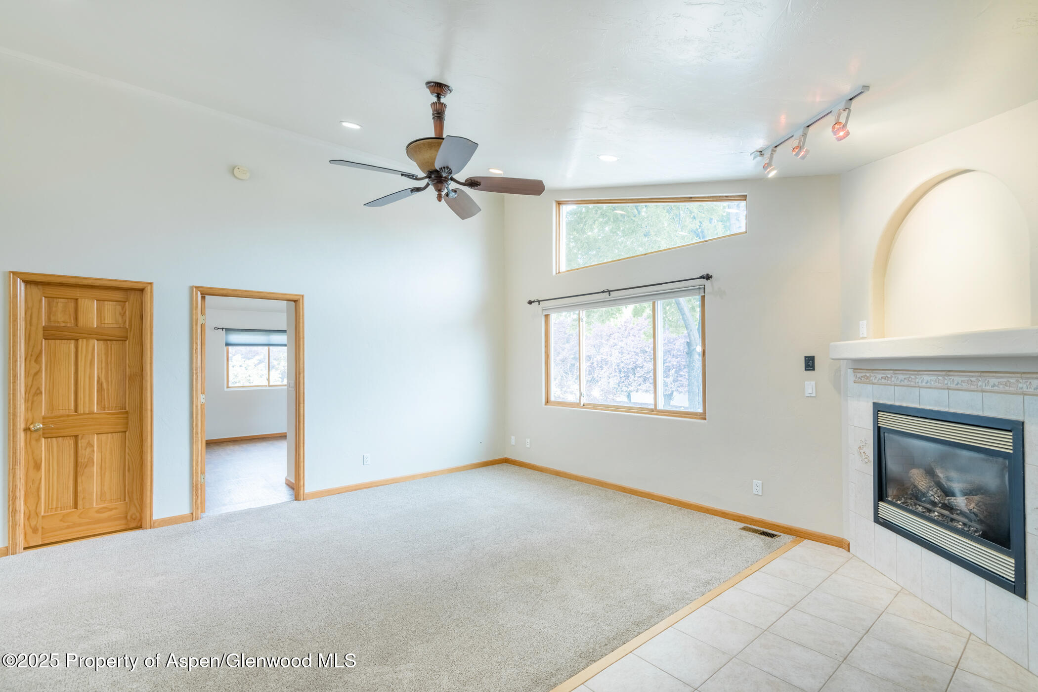 1230 Fir Avenue Rifle, CO 81650 - Photo 7 of 34 a view of an empty room with a fireplace and a window