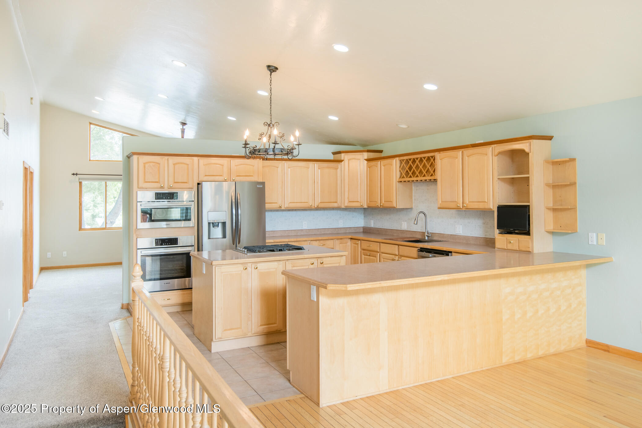 1230 Fir Avenue Rifle, CO 81650 - Photo 9 of 34 a kitchen with stainless steel appliances granite countertop a sink a stove and a refrigerator