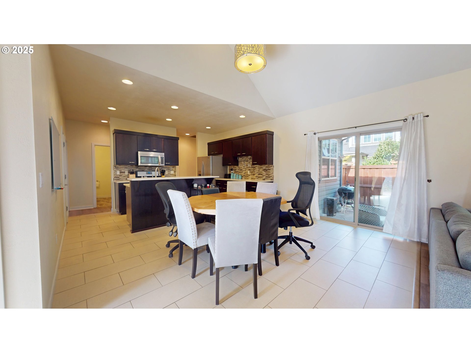 375 Mia Lane Eugene, OR 97401 - Photo 11 of 44 a living room with stainless steel appliances kitchen island a table and chairs