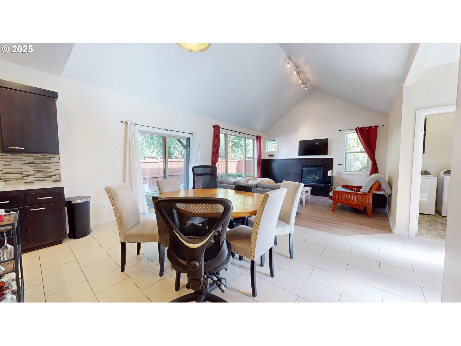 375 Mia Lane Eugene, OR 97401 - Photo 10 of 44 a living room with furniture a flat screen tv and a refrigerator