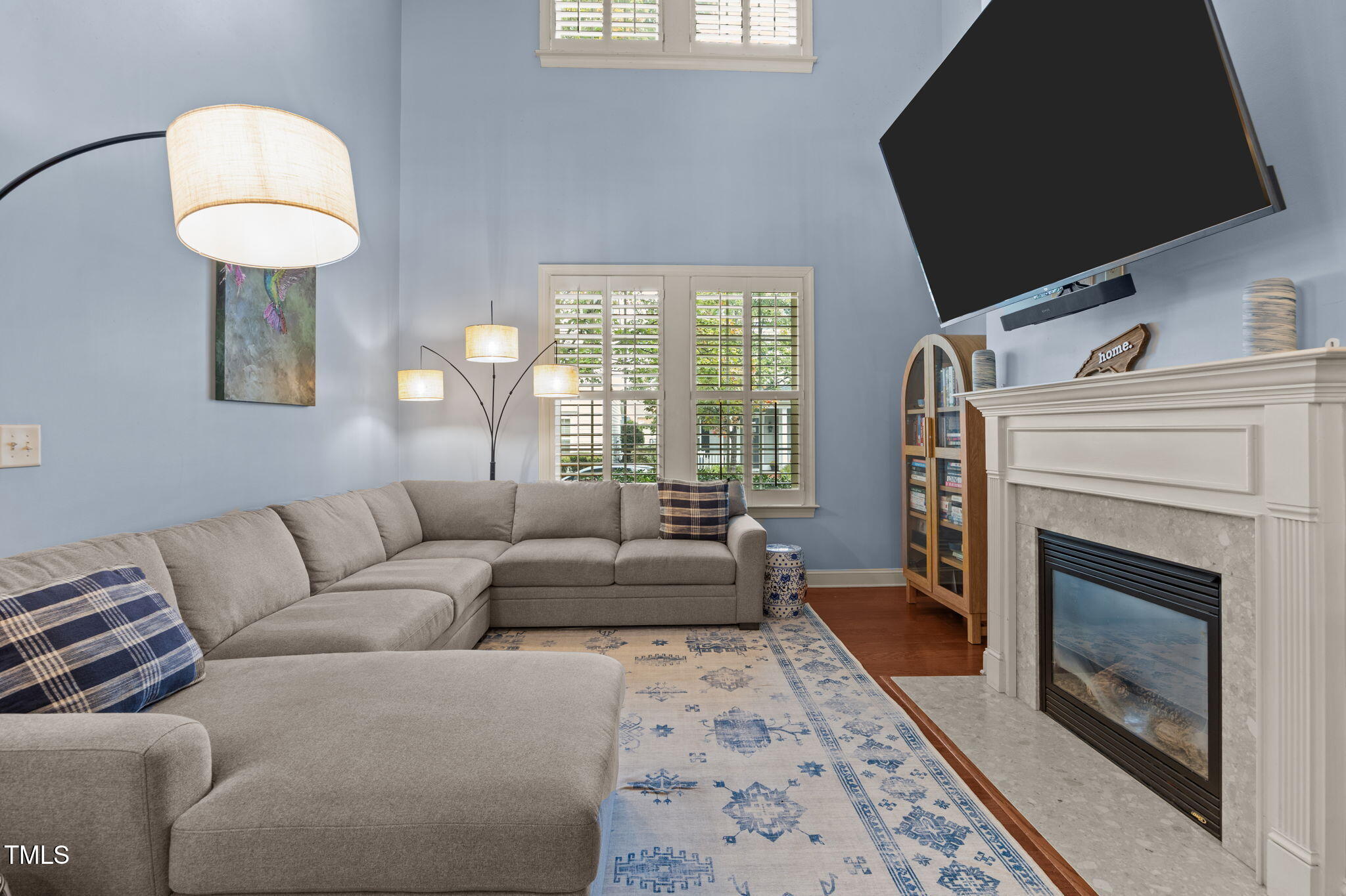 831 Historian Street Raleigh, NC 27603 - Photo 18 of 52 a living room with furniture a fireplace and a flat screen tv