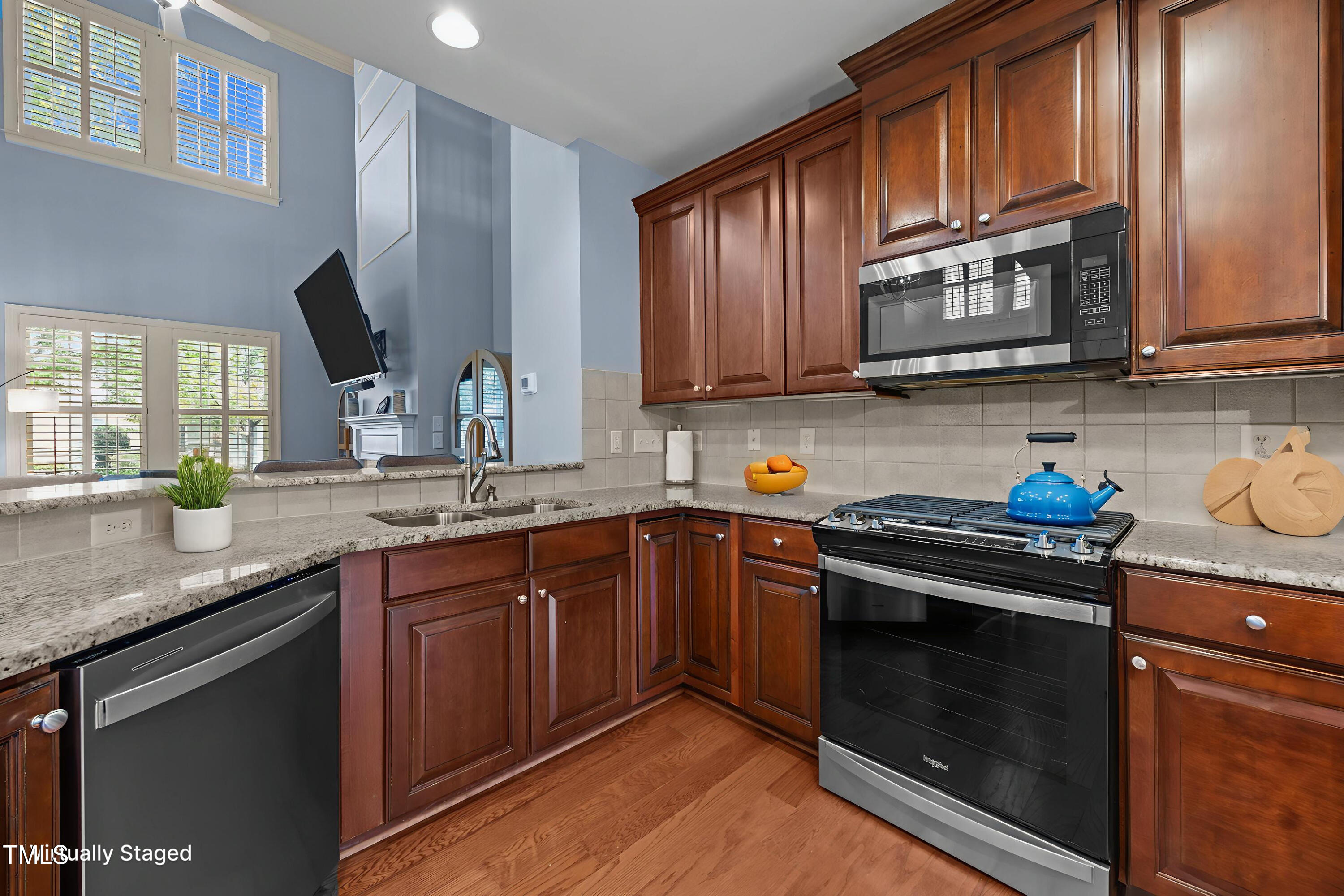 831 Historian Street Raleigh, NC 27603 - Photo 20 of 52 a kitchen with granite countertop cabinets stainless steel appliances and a sink