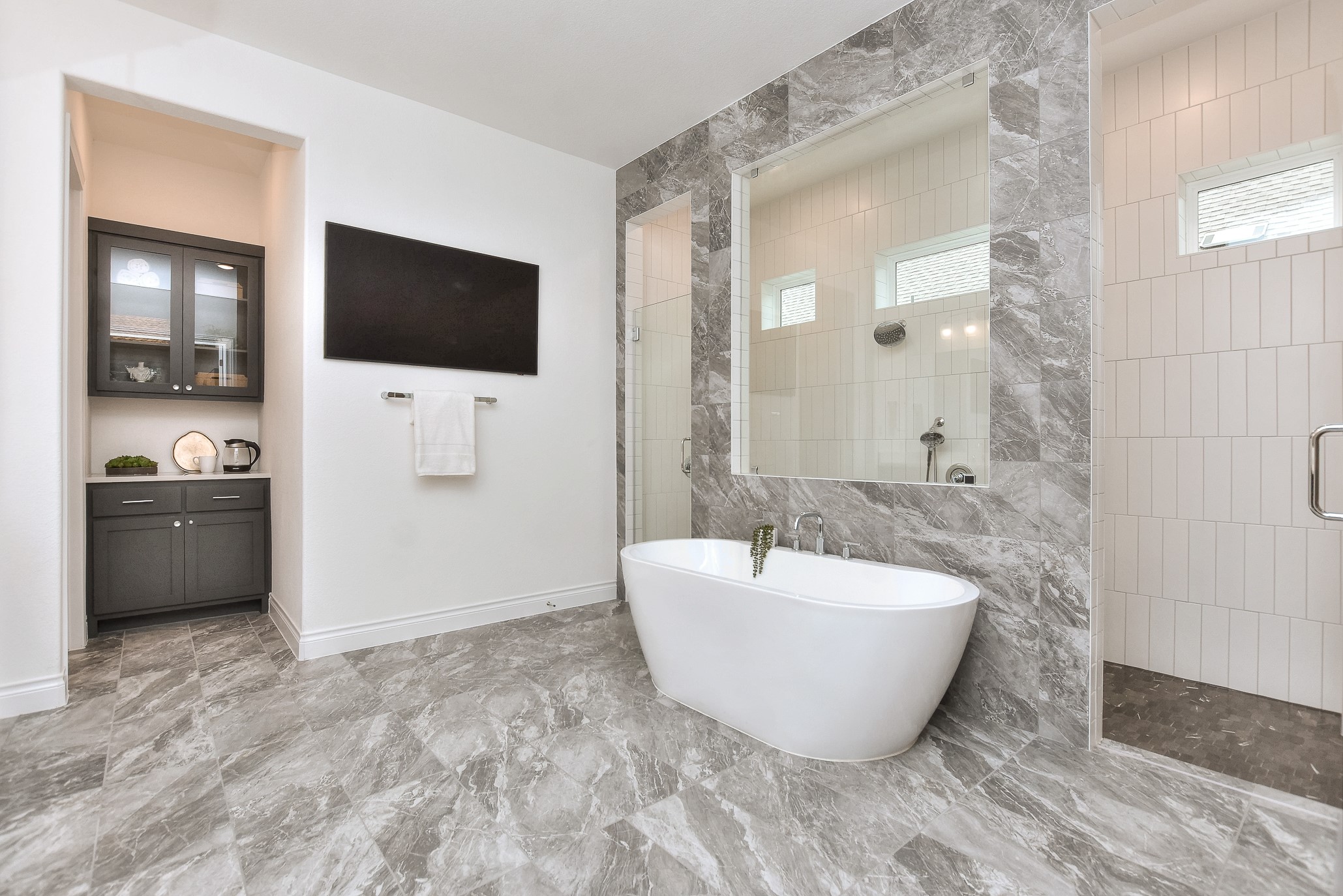 309 Wolf Rdg Road Georgetown, TX 78628 - Photo 18 of 39 Full bath with a shower stall, vanity, a freestanding tub, tile walls, and light marble finish floors