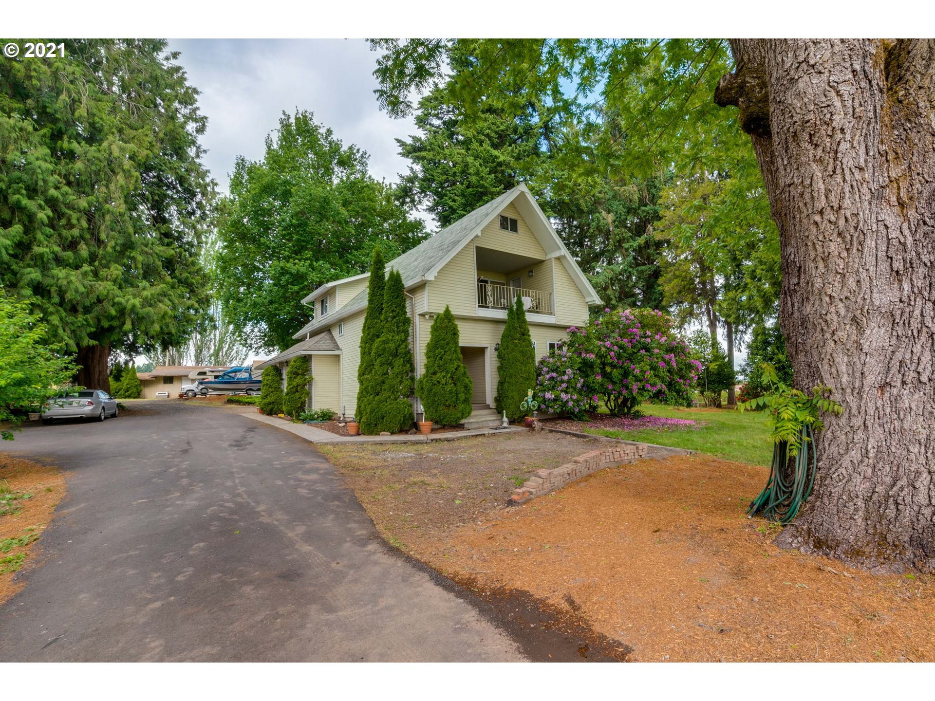 2559 Southwest Dilley Road Forest Grove, OR 97116 - Photo 1 of 32 a front view of a house with a yard and garage