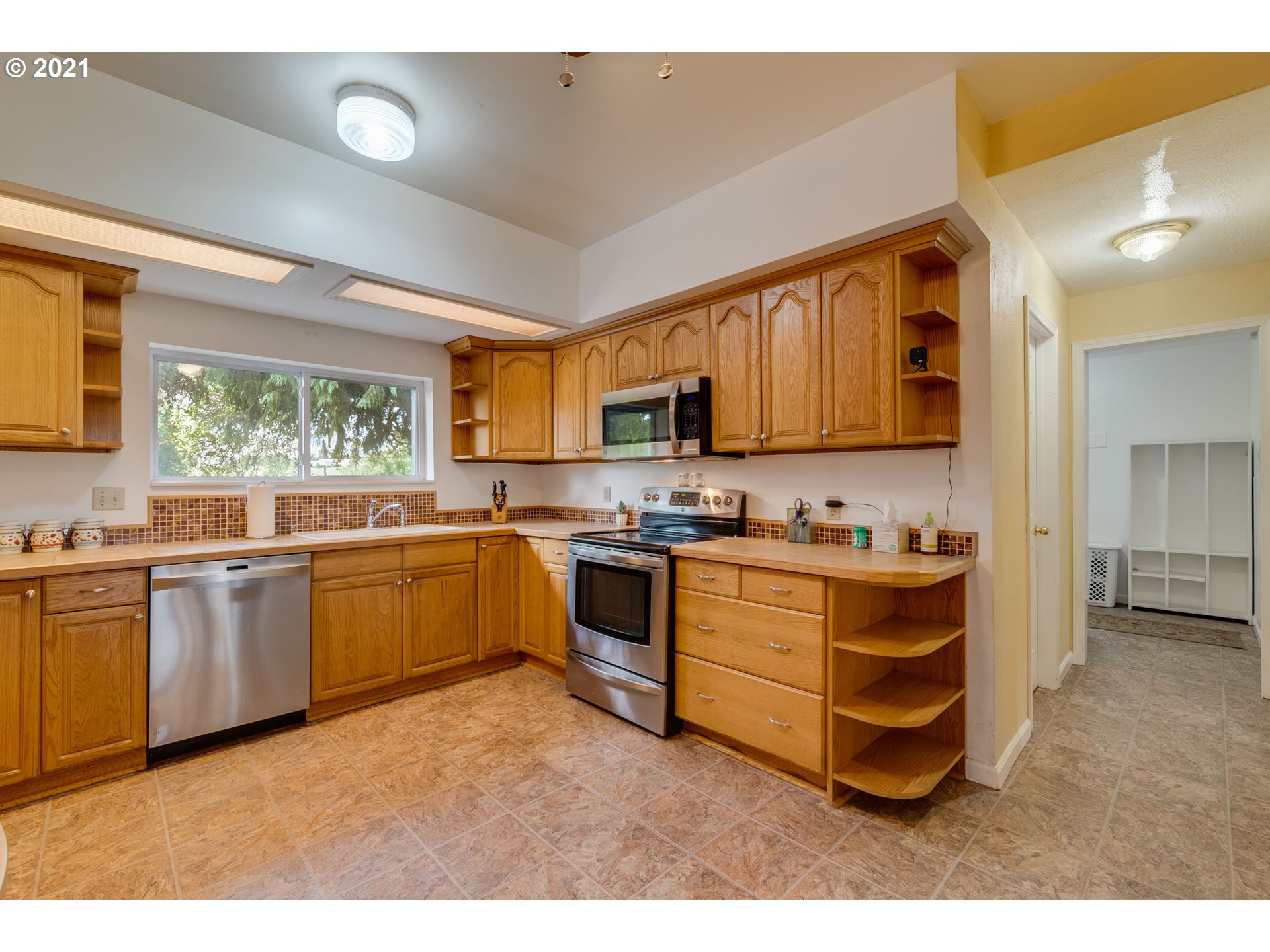 2559 Southwest Dilley Road Forest Grove, OR 97116 - Photo 13 of 32 a kitchen with stainless steel appliances granite countertop a stove sink and cabinets