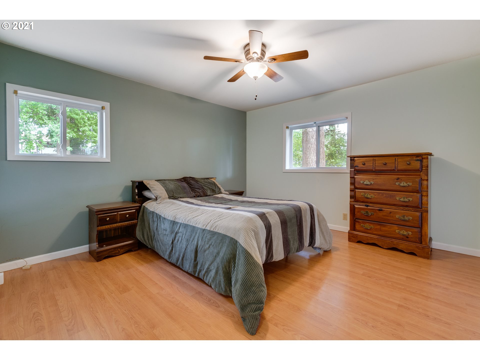 2559 Southwest Dilley Road Forest Grove, OR 97116 - Photo 17 of 32 a bedroom with a bed and a chandelier