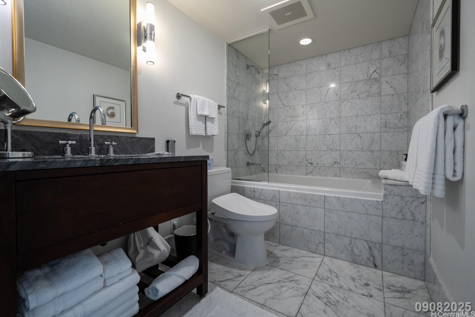 223 Saratoga Road, Unit 918 Honolulu, HI 96815 - Photo 14 of 25 a bathroom with a sink toilet a shower and a mirror
