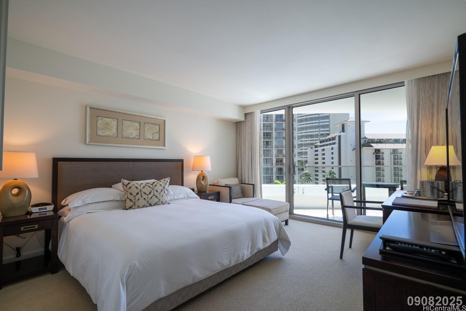 223 Saratoga Road, Unit 918 Honolulu, HI 96815 - Photo 7 of 25 a bedroom with a bed a couch and a large window with balcony view